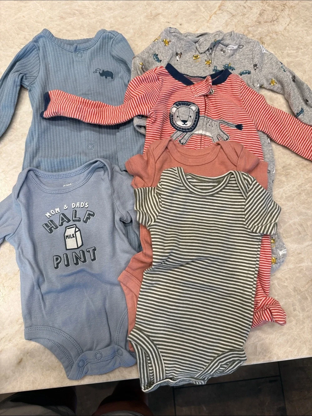Carter’s baby clothes: 3 footie pajamas, 3 onesies newborn size